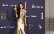 Demi Moore with her Golden Globe for Best Performance by a Female Actor in a Motion Picture Musical or Comedy for "The Substance" at the 82nd Golden Globe Awards (Image via Jason Armond / Los Angeles Times via Getty Images)